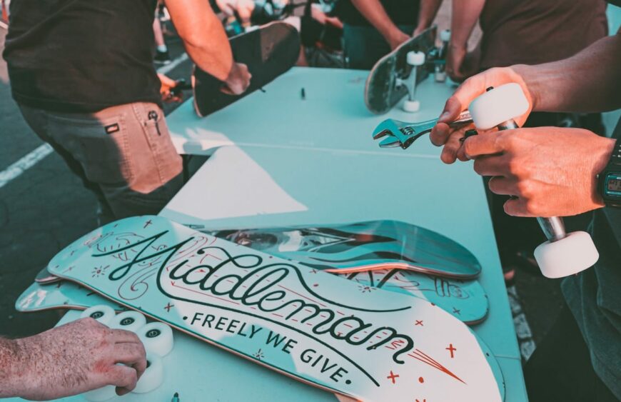 a group of people standing around a table with a skateboard